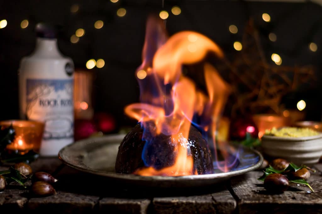 Flamed Rock Rose Christmas Pudding on a plate