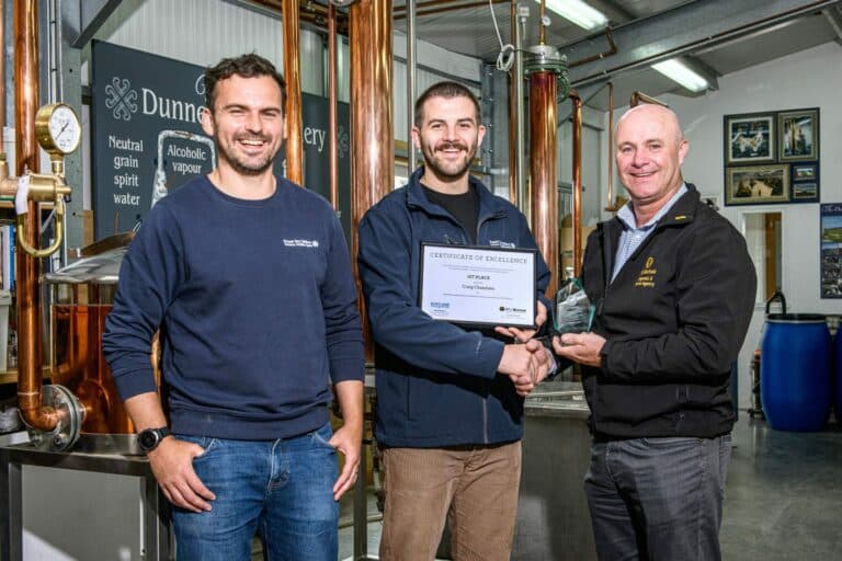 Craig Chambers holding his award and certificate of excellence with Martin Murray and Graham Laing